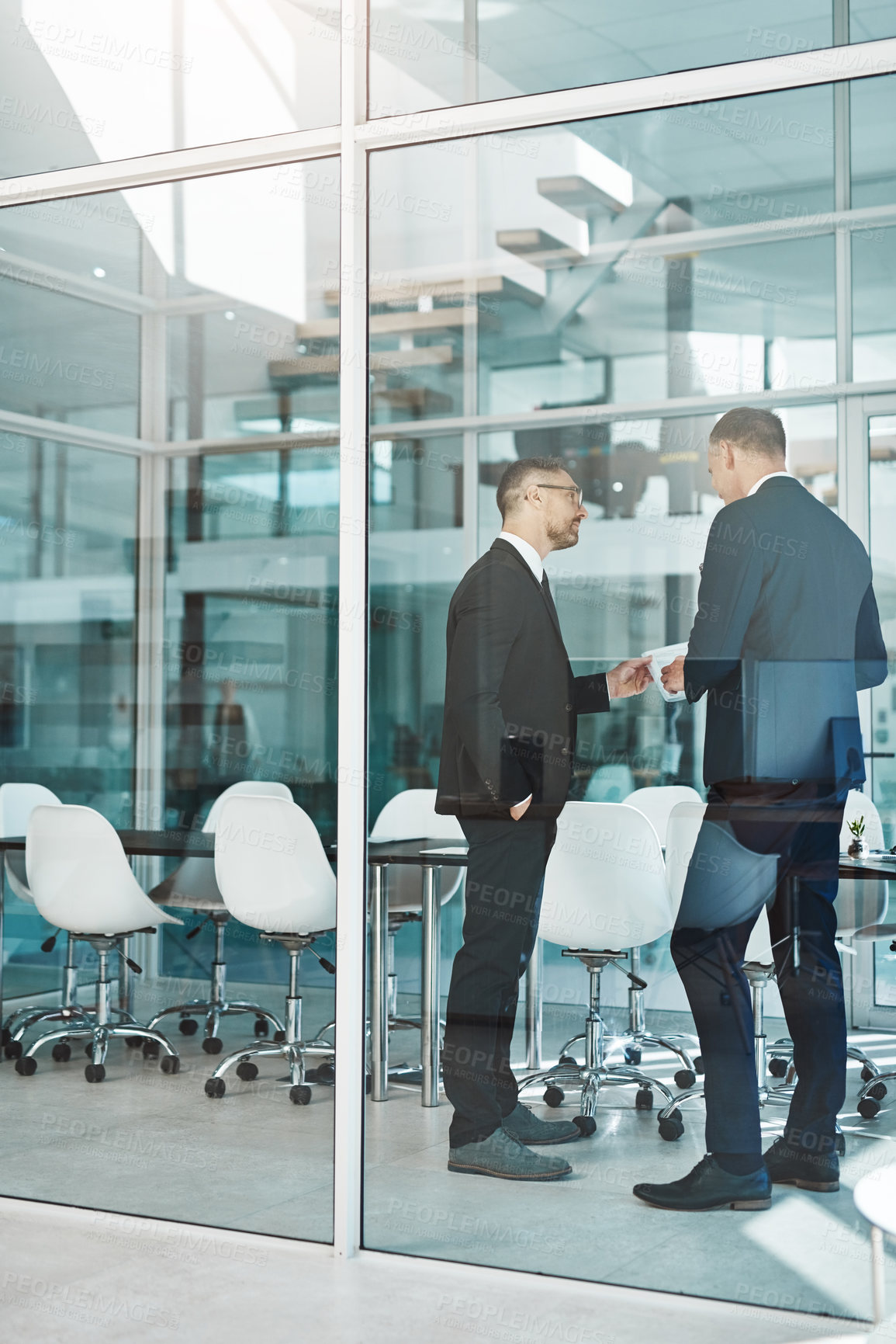 Buy stock photo Full length shot of two corporate businessmen meeting in the boardroom