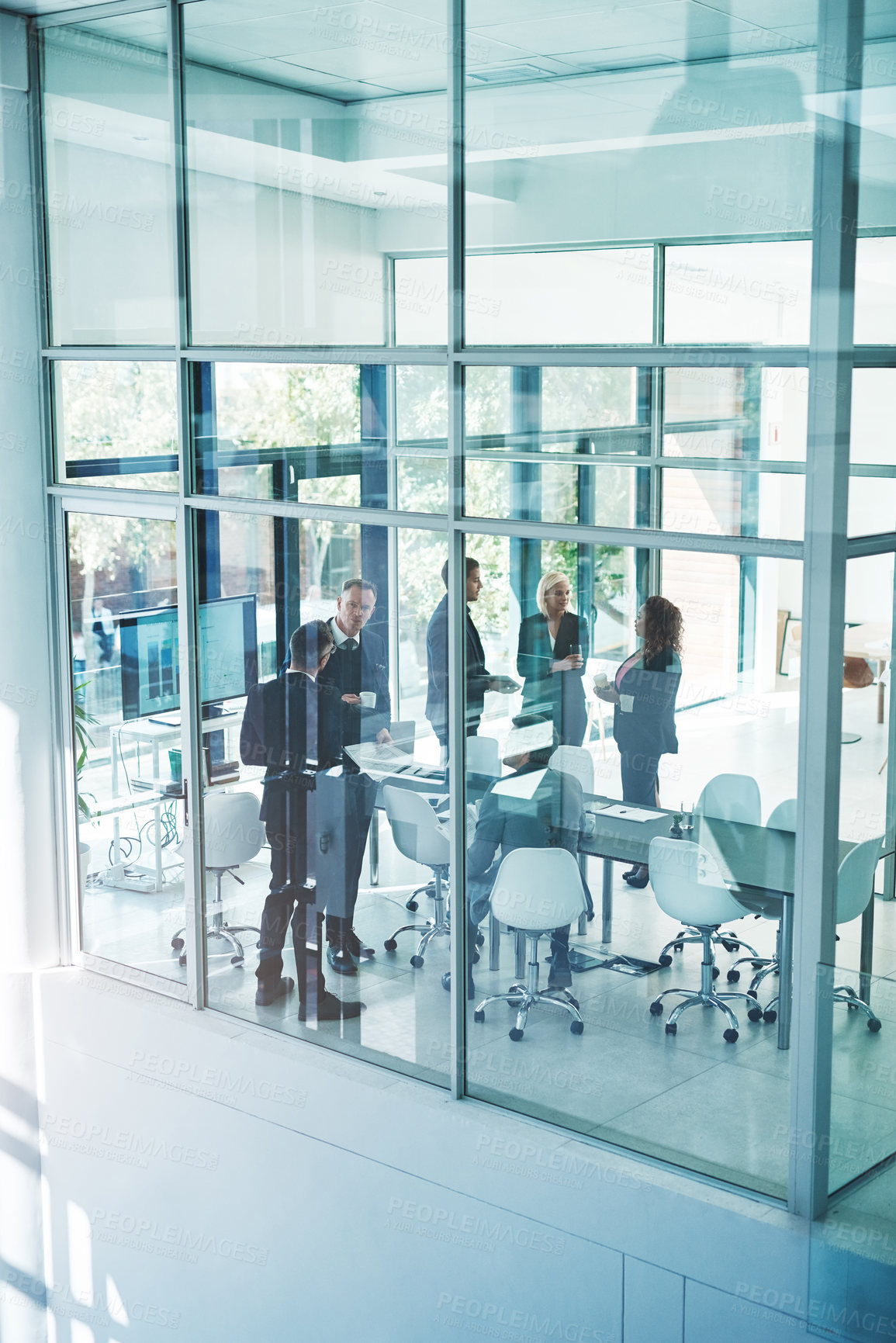 Buy stock photo High angle shot of a group of corporate businesspeople meeting in the boardroom