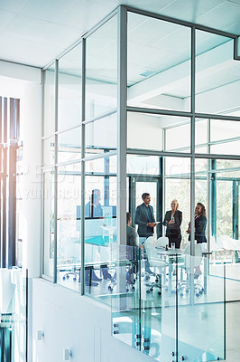 Buy stock photo Full length shot of a group of corporate businesspeople meeting in the boardroom