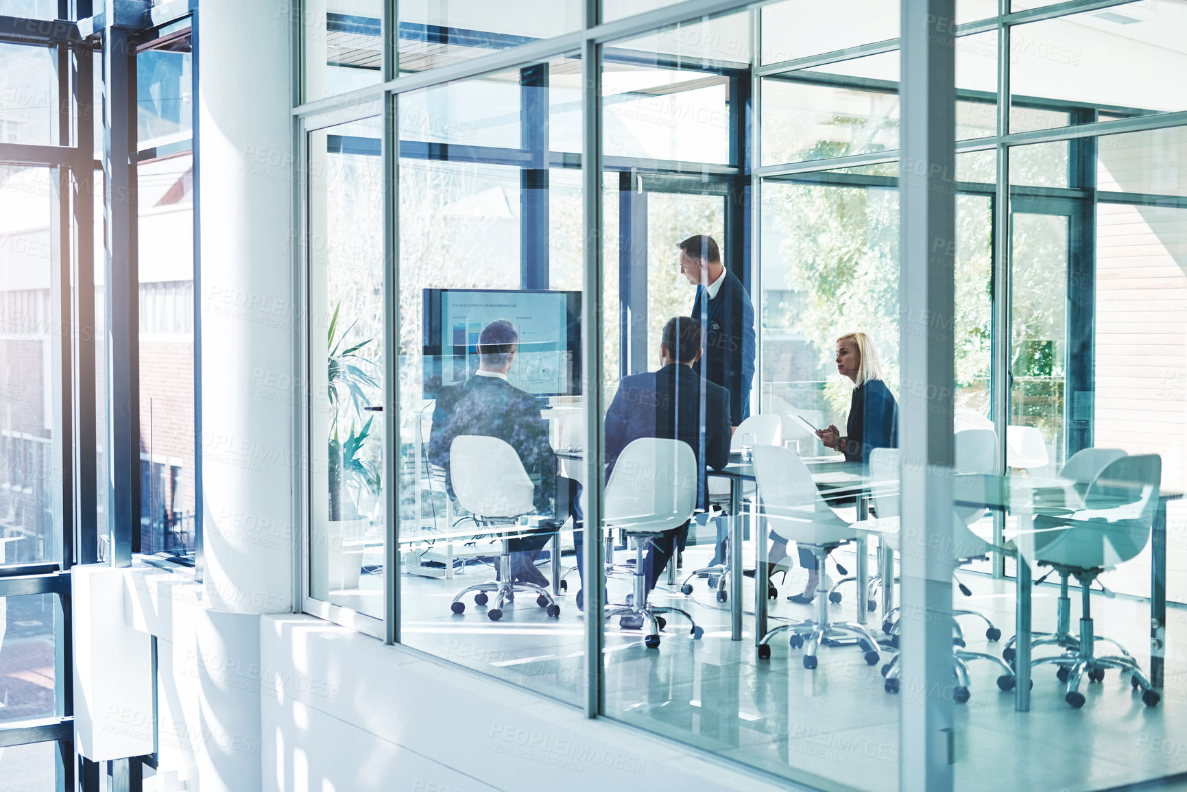 Buy stock photo Full length shot of a group of corporate businesspeople meeting in the boardroom