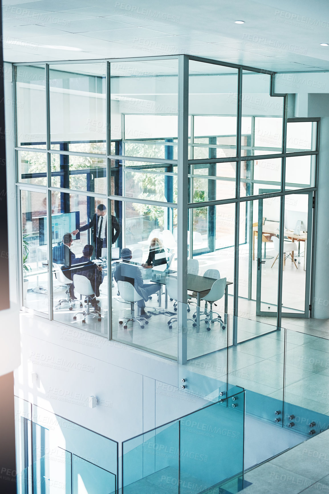 Buy stock photo High angle shot of a group of corporate businesspeople meeting in the boardroom