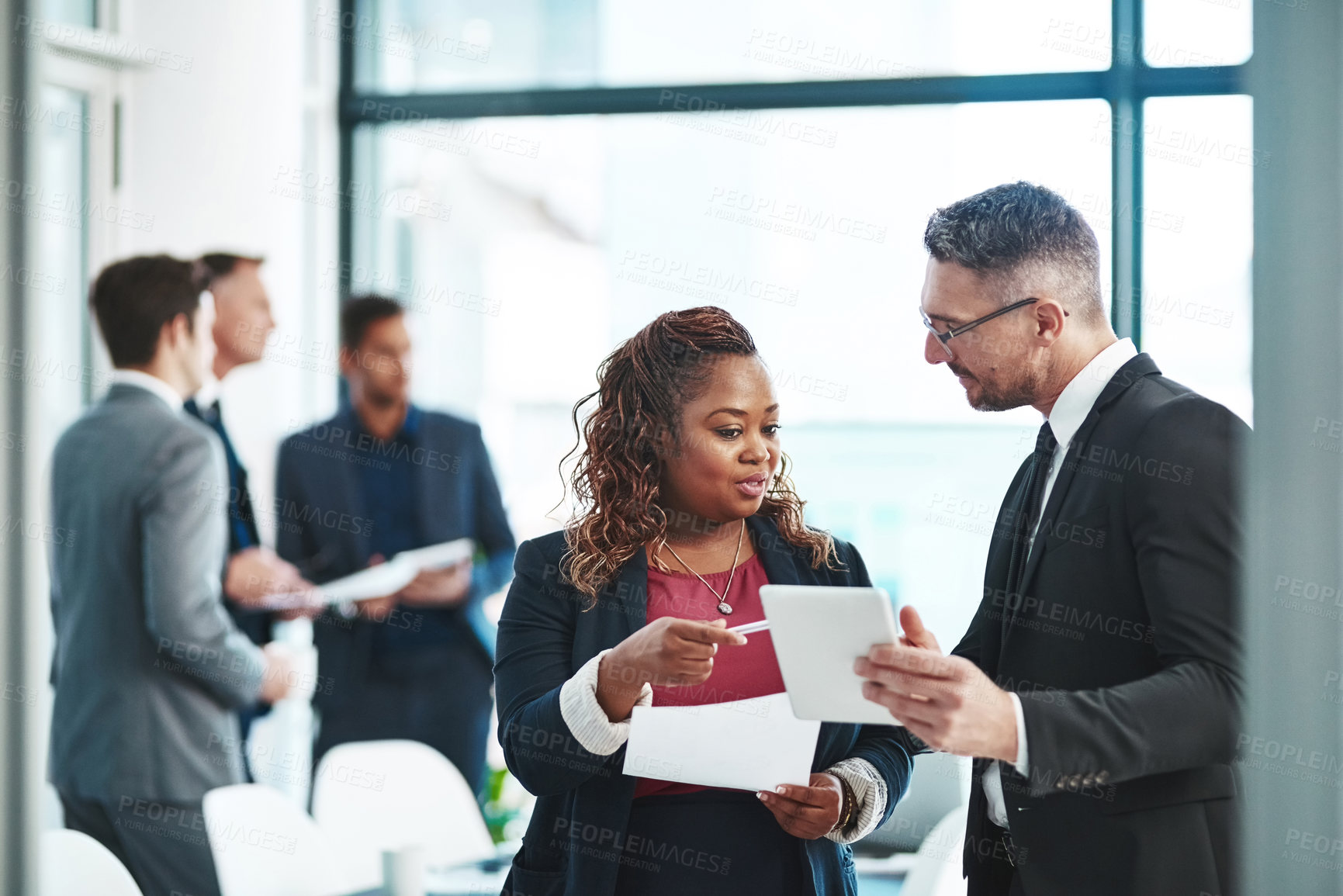 Buy stock photo Cropped shot of two corporate businesspeople talking before their meeting in the boardroom