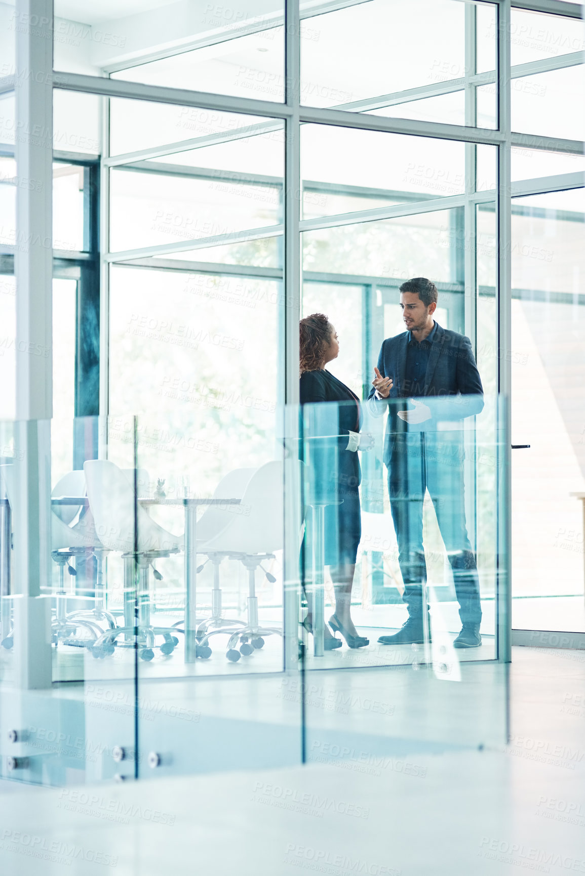 Buy stock photo Full length shot of two corporate businesspeople talking before their meeting in the boardroom