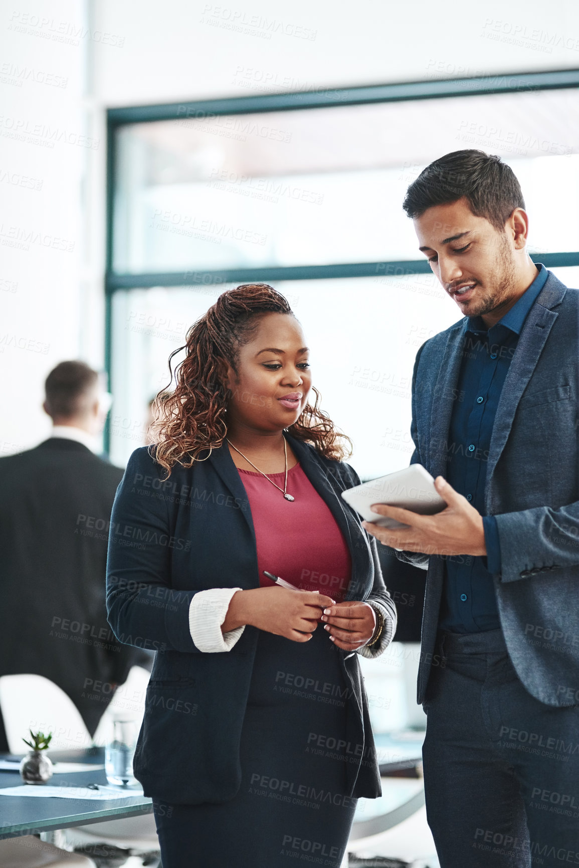 Buy stock photo Cropped shot of two corporate businesspeople talking before their meeting in the boardroom