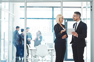 Buy stock photo Cropped shot of two corporate businesspeople talking before their meeting in the boardroom