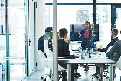 Buy stock photo Full length shot of an attractive young businesswoman giving a presentation in the boardroom