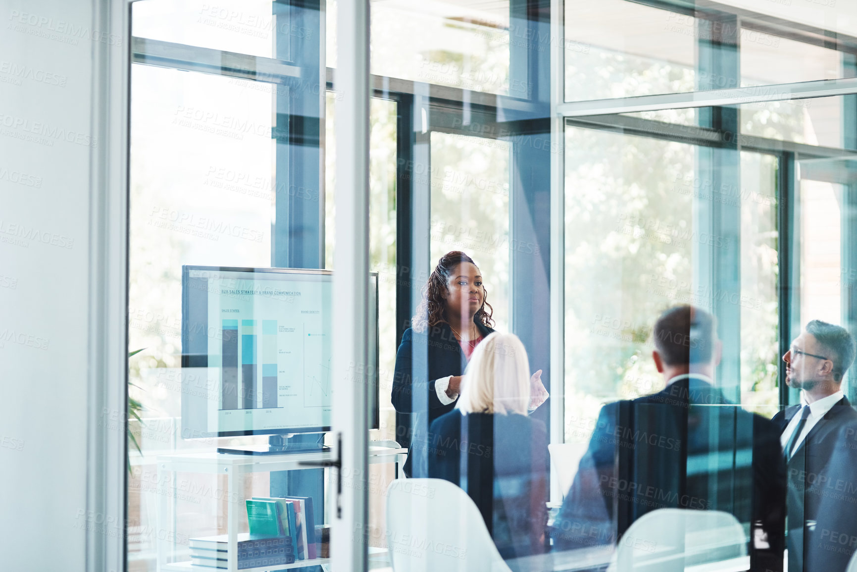 Buy stock photo Meeting, presentation and woman with business people in office for financial review, teamwork and collaboration. Corporate, company and workers in glass boardroom for charts, statistics or discussion