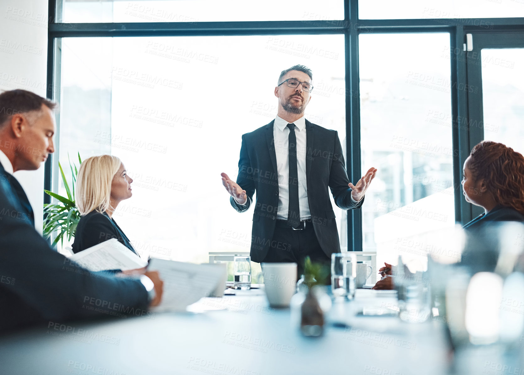 Buy stock photo Cropped shot of a handsome mature businessman giving a presentation in the boardroom