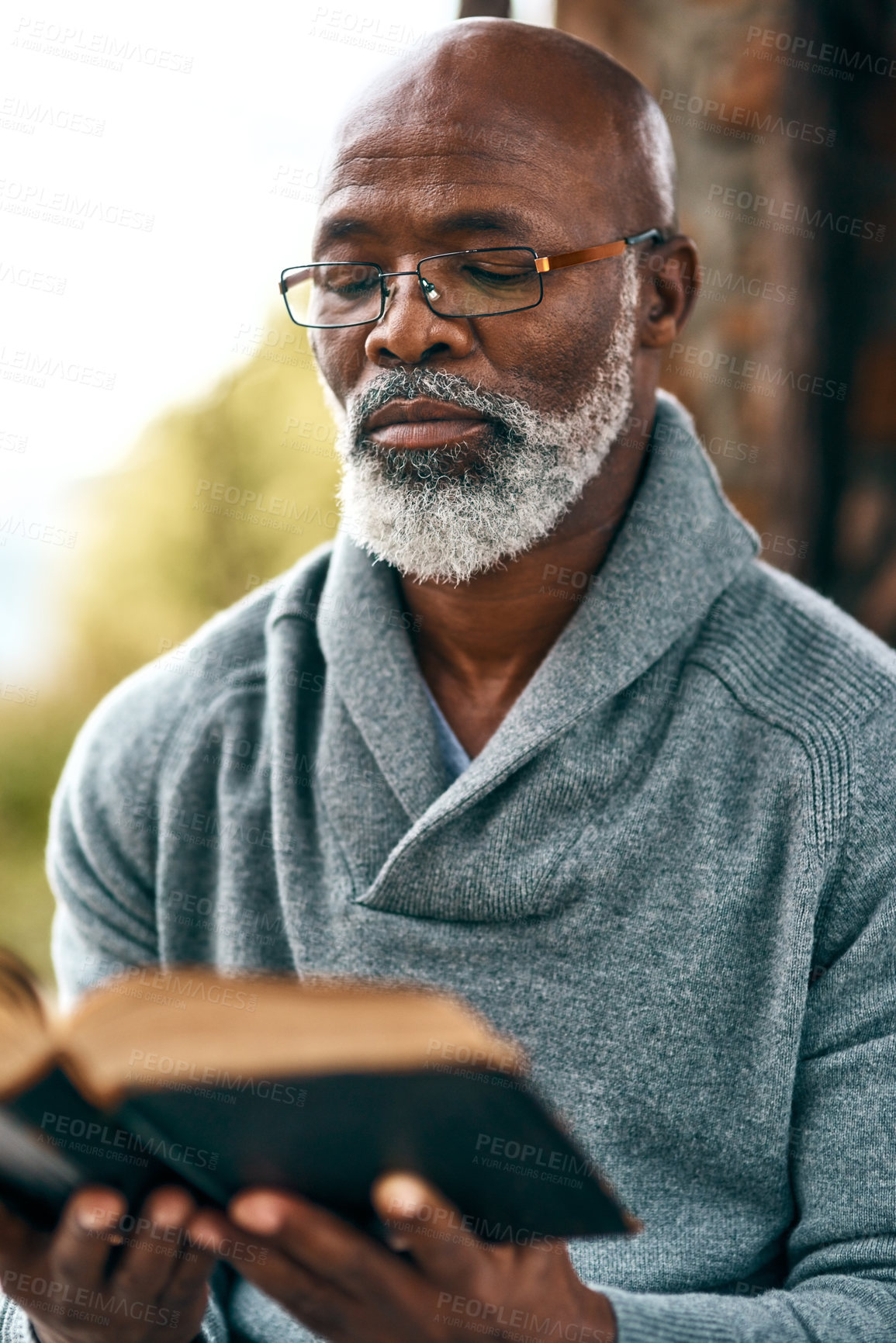 Buy stock photo Senior, park and black man reading bible in spiritual religion for peace, guidance and learning. Book, education or worship in nature with praise, scripture and gratitude for prayer, faith and gospel