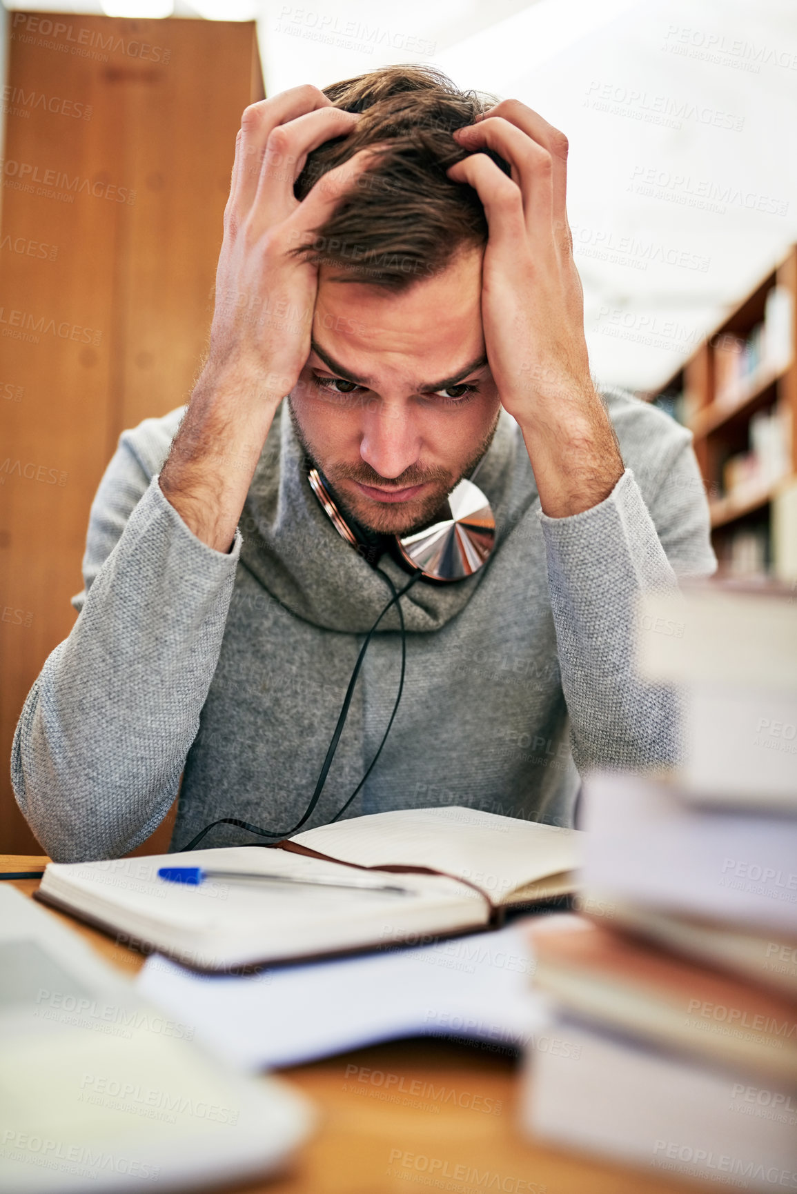 Buy stock photo Man, student and stressing in library with notebook, education and knowledge study for learning university person. Burnout, anxiety and mental health for research assignment, frustrated and project