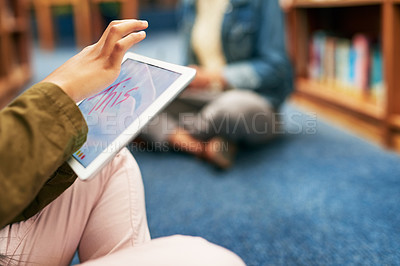 Buy stock photo Closeup shot of an unrecognisable university student using a digital tablet in the library at campus