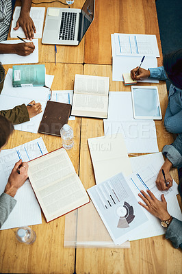 Buy stock photo High angle shot of a group of unrecognizable university students studying in the library