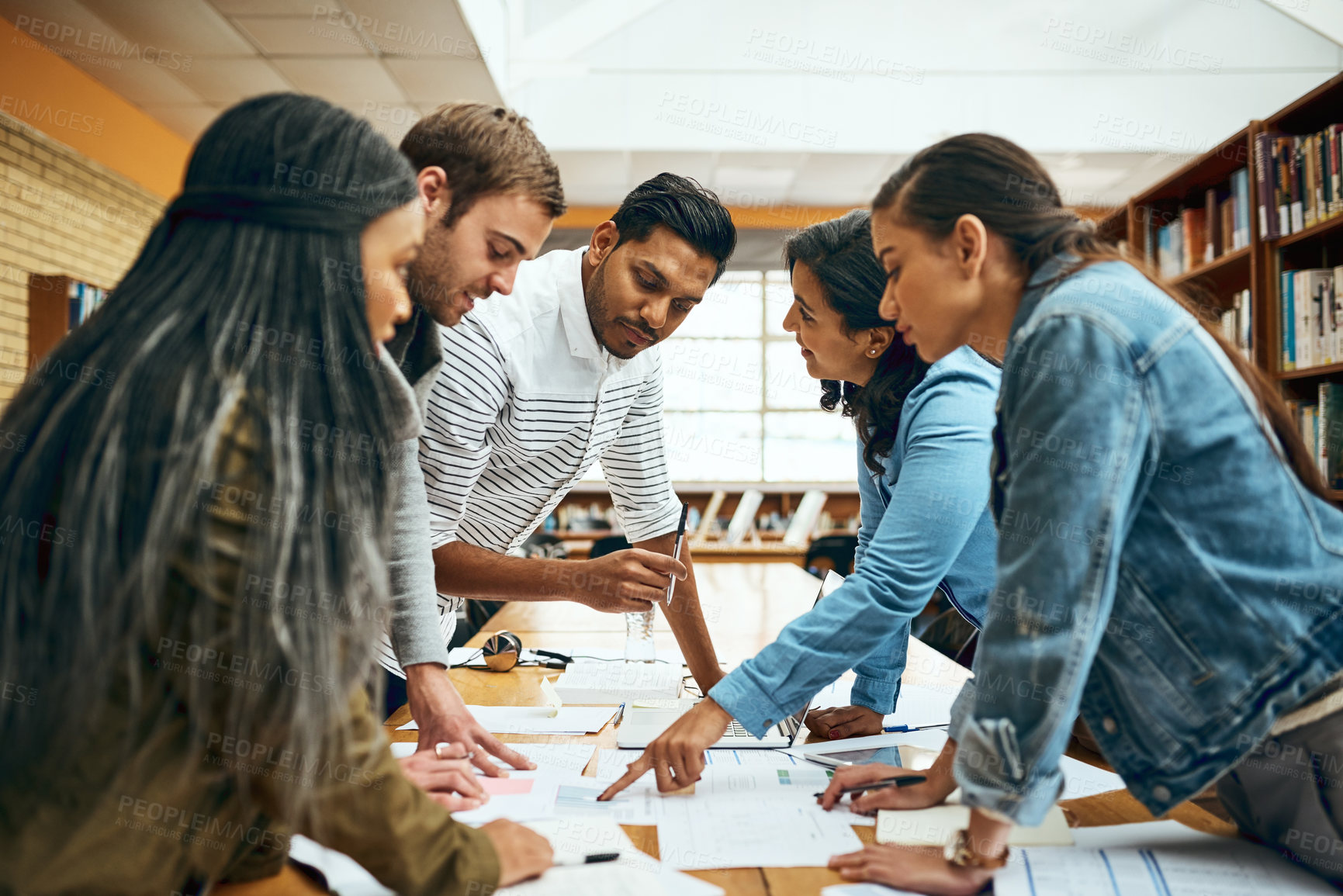 Buy stock photo Library, college student and study group with discussion for research, teamwork and collaboration on campus. People, classmates and university learner with documents or notes assignment and project