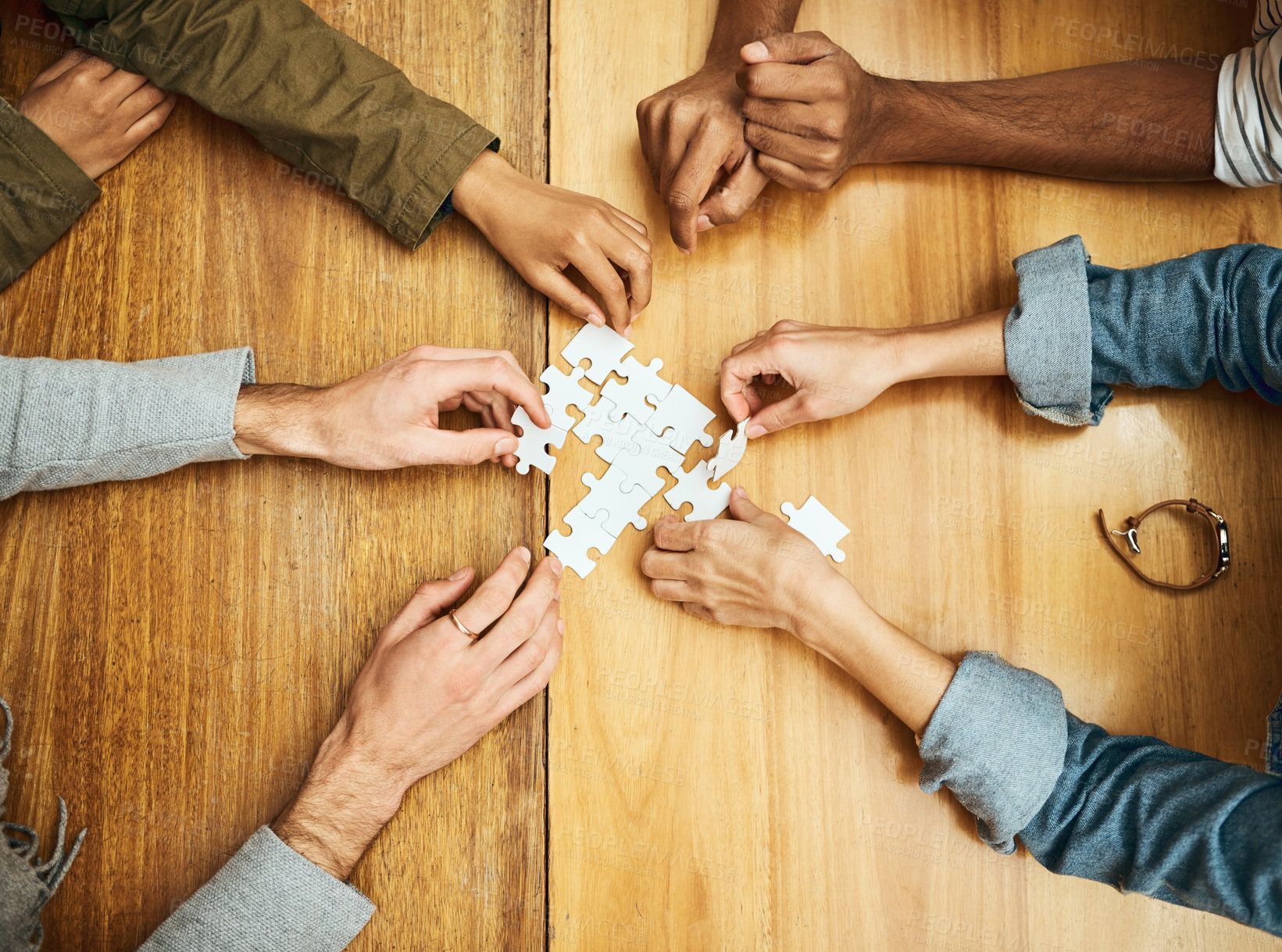 Buy stock photo Puzzle, meeting and hands of business people for teamwork, collaboration and working together. Creative office, diversity and workers with jigsaw for problem solving, integration and cooperation