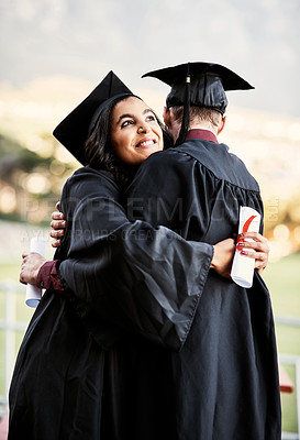 Buy stock photo Shot of two students hugging each other on graduation day