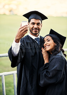 Buy stock photo Shot of two students taking a selfie together on graduation day