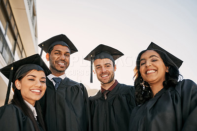 Buy stock photo Portrait of a group of students standing together on graduation day