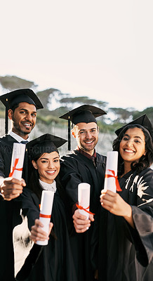 Buy stock photo Portrait of a group of students celebrating with their diplomas on graduation day