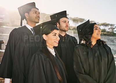 Buy stock photo Shot of a group of students standing together on graduation day