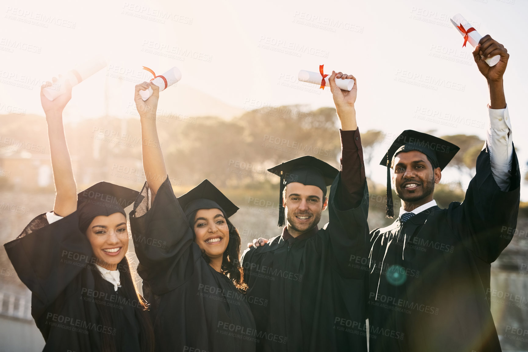 Buy stock photo Portrait of a group of students celebrating with their diplomas on graduation day