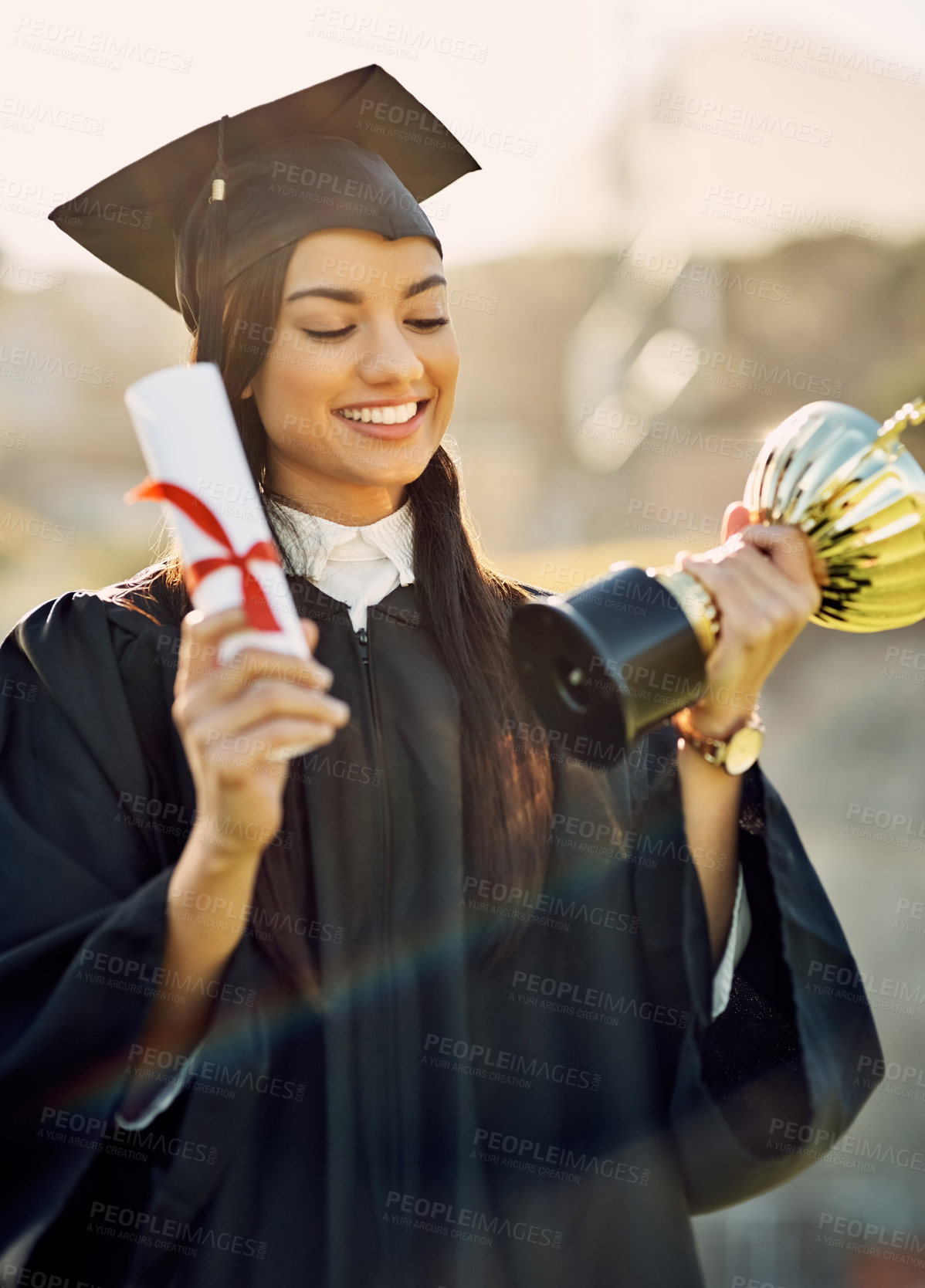 Buy stock photo Graduation, student and girl with trophy or diploma outdoor for degree ceremony, achievement and excited. College graduate, woman and scholarship success with academic milestone or certificate event
