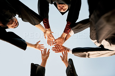 Buy stock photo Closeup shot of a group of students joining their hands together in celebration on graduation day