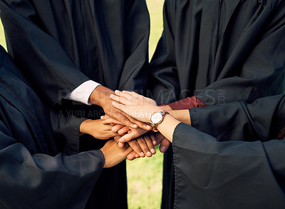 Buy stock photo Closeup shot of a group of students joining their hands together on graduation day