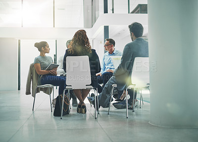 Buy stock photo Shot of a group of coworkers talking together while sitting in a circle in an office