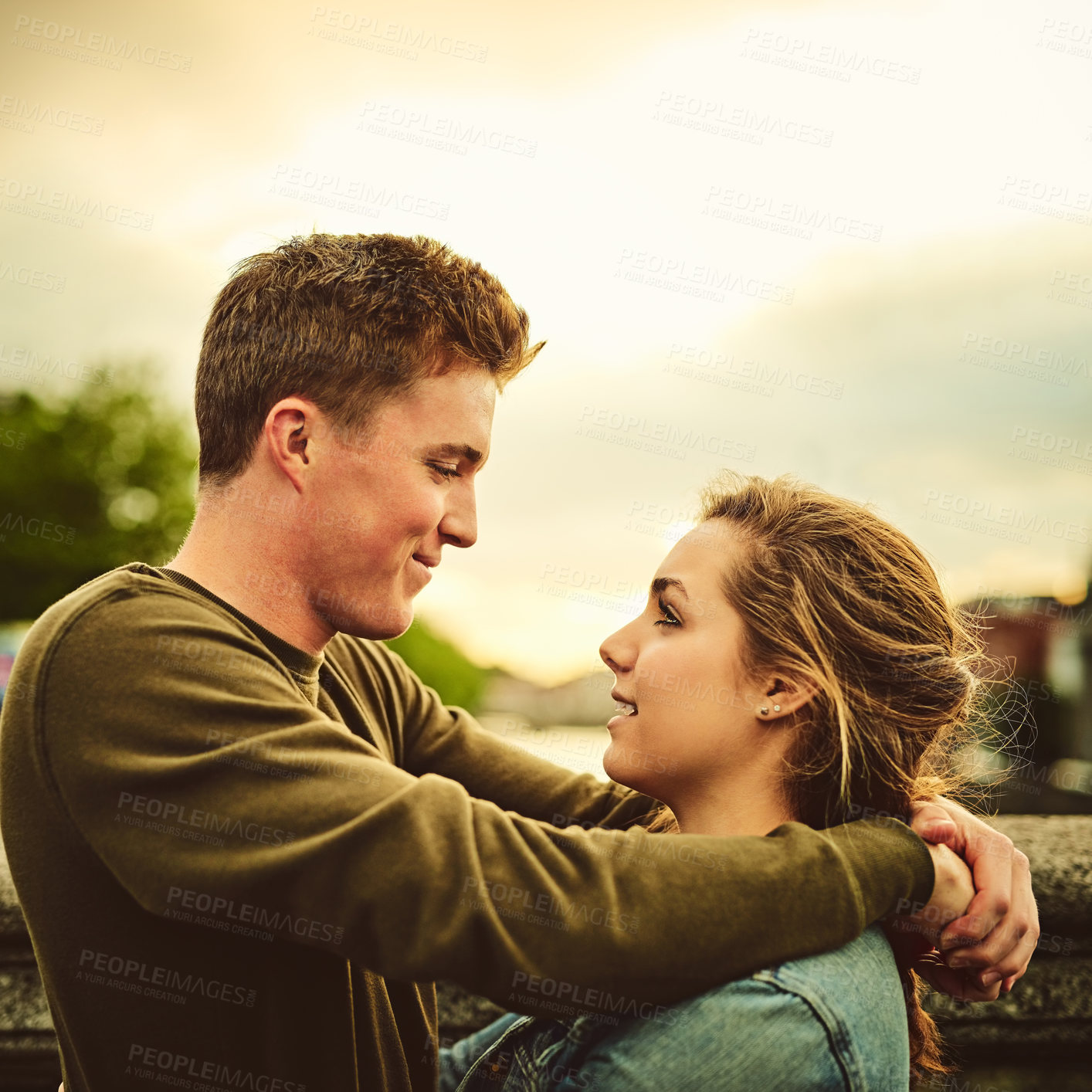 Buy stock photo Happy couple, hug and embrace with love in city for support, relax or outdoor travel together. Young man, woman or lovers with smile, comfort or affection on romantic holiday or trip in an urban town