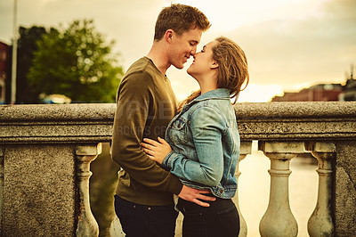 Buy stock photo Happy couple, kiss and hug with love in city for embrace, affection or intimacy on outdoor holiday together. Young man, woman or lovers touching for romantic date, commitment or care in an urban town