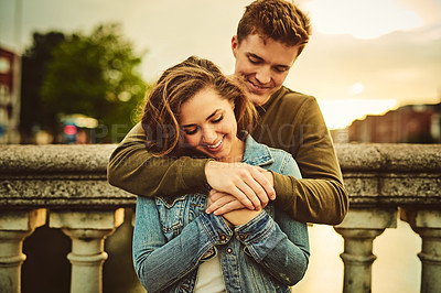 Buy stock photo Happy couple, hug and comfort with love in city for warm embrace, support or outdoor travel together. Young man, woman or lovers with smile for affection, romantic holiday or trip in an urban town