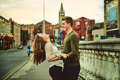 Buy stock photo Happy couple, dancing and travel to city, holiday and trip to Amsterdam on weekend vacation. People, holding hands and urban town for outdoor freedom, support and walking in Netherlands for love