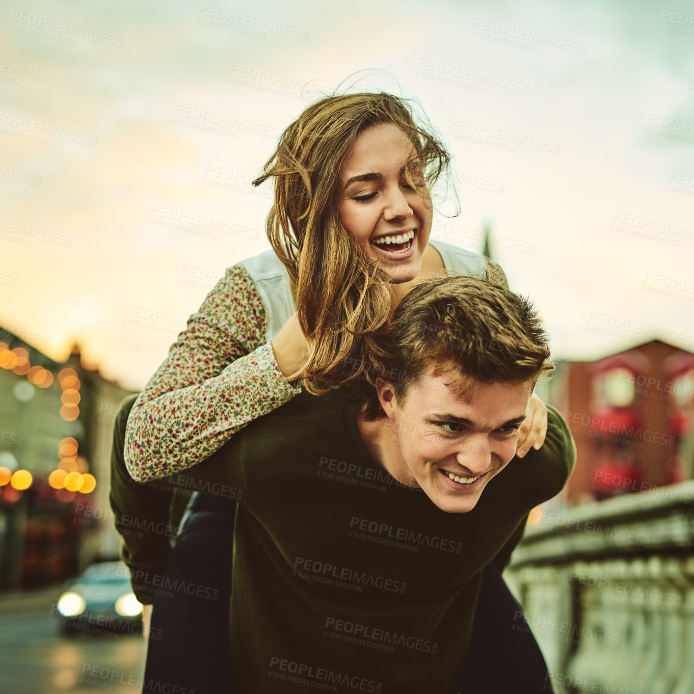 Buy stock photo Couple, piggyback and happy in city for love, support or trust in relationship. Woman, man or carry on street for journey, date and bonding at sunset with fun memories or freedom in town for travel