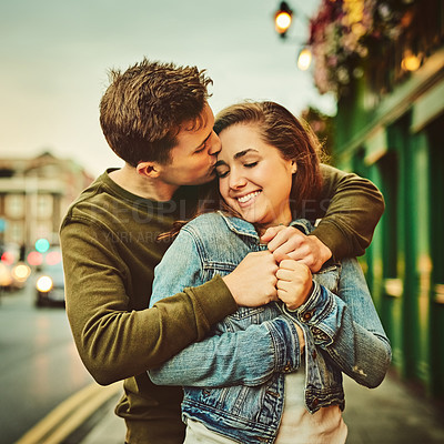 Buy stock photo Happy couple, hug and embrace with love in city for warmth, support or comfort on sidewalk. Young man, woman or lovers with smile for kiss, affection or romantic date on holiday trip in an urban town