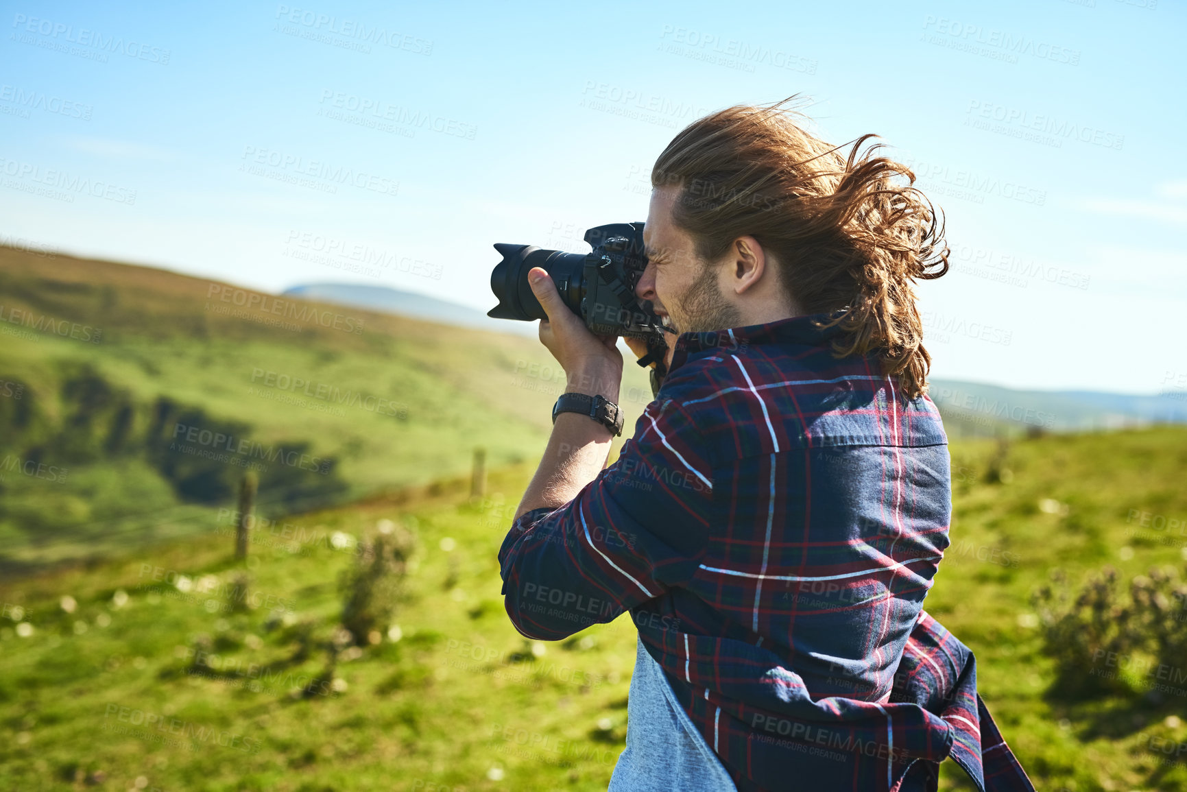 Buy stock photo Shot of a man taking photographs with his camera outdoors