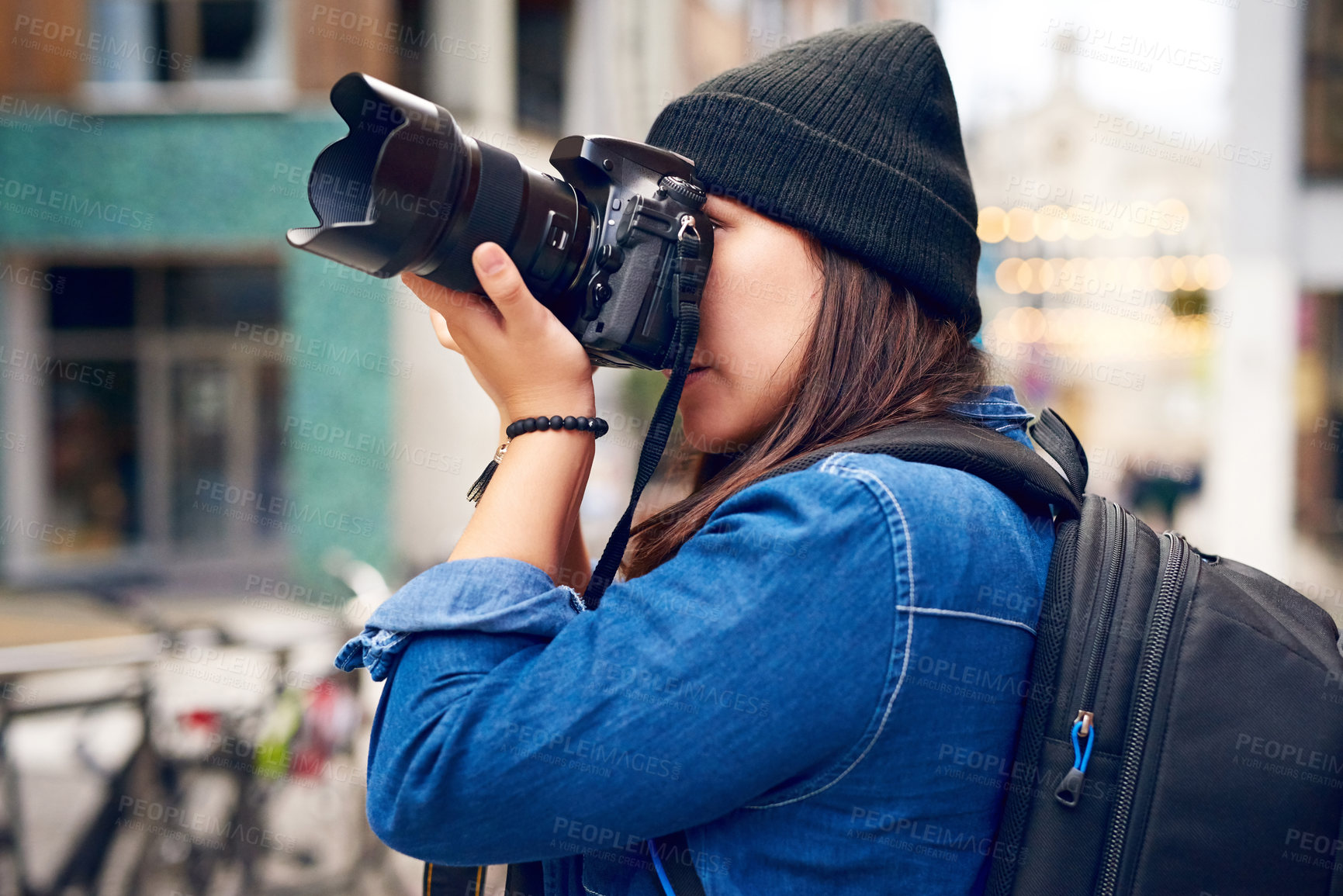 Buy stock photo Shot of a woman taking pictures with her camera outside 