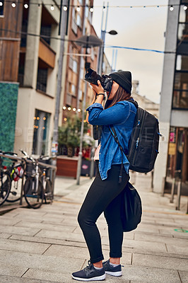 Buy stock photo Shot of a woman taking pictures with her camera outside 