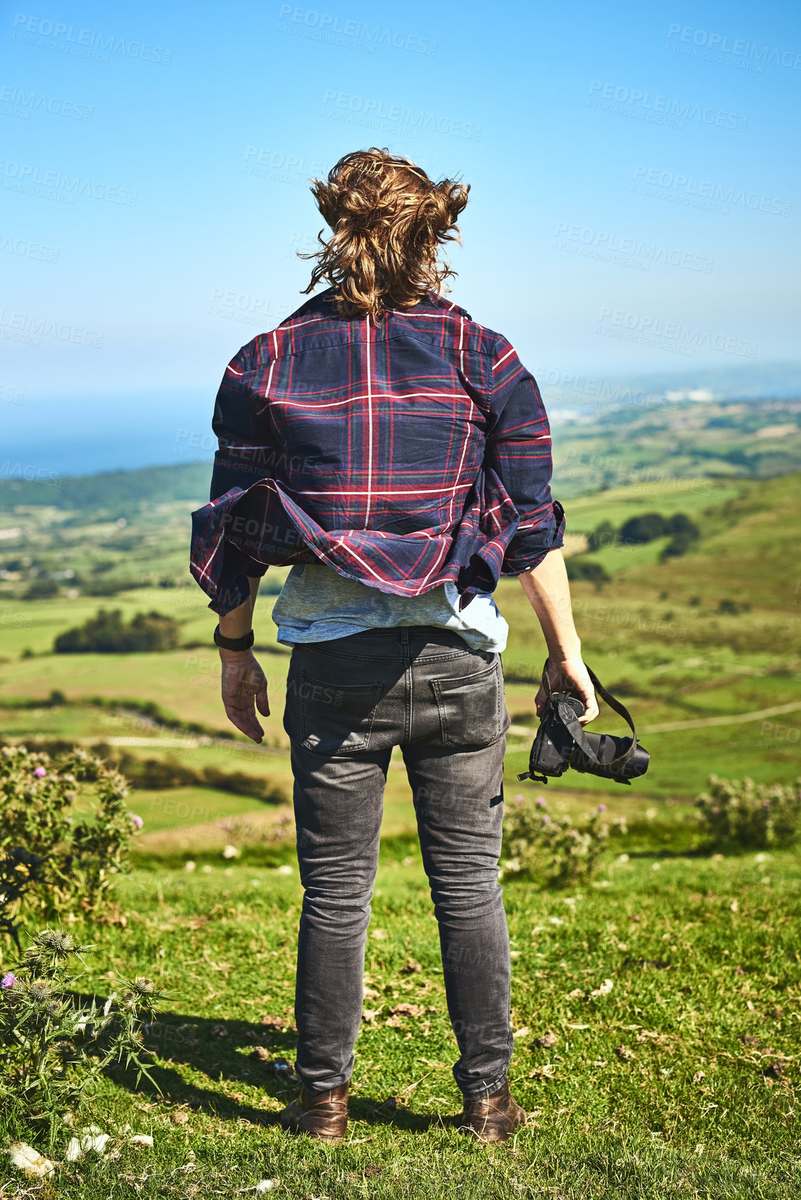 Buy stock photo Nature, photography and back of man in countryside with camera, view and adventure in meadow. Professional photographer, thinking and outdoor with tech for creativity, environment and calm in Norway