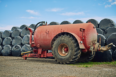 Buy stock photo Agriculture, slurry tanker and storage on farm with equipment for industrial agribusiness. Container, gear or machinery with liquid manure spreader in countryside for natural fertilization outdoor