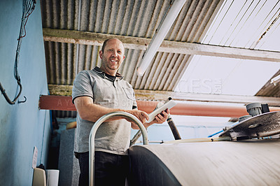 Buy stock photo Man, portrait and farmer with machine, low angle and container for milk, organic produce and natural. Person, entrepreneur and business owner with documents, industrial and eco friendly in factory