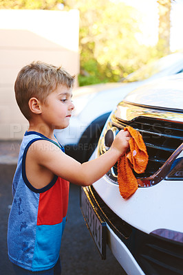 Buy stock photo Cropped shot of an adorable little boy washing a car outside