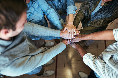 Buy stock photo High angle shot of a group of unrecognizable university students standing with their hands in a huddle