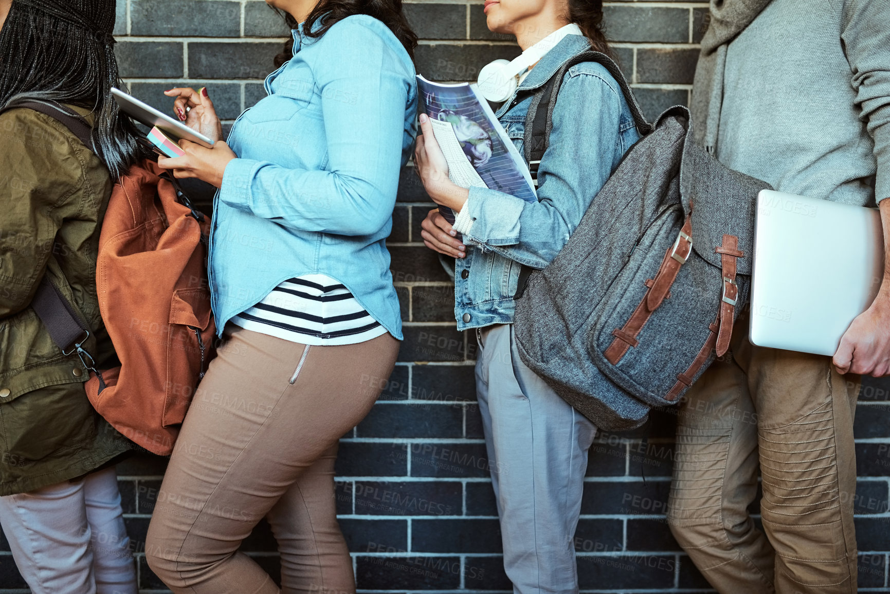 Buy stock photo Cropped shot of a
 group of unrecognizable university students standing in a campus corridor