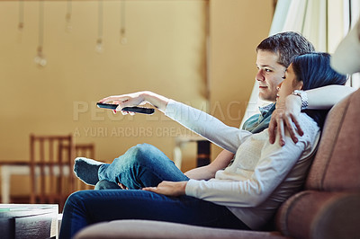 Buy stock photo Shot of a couple watching television at home
