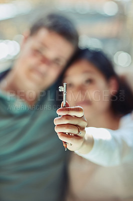 Buy stock photo Shot of a couple holding the keys to their home