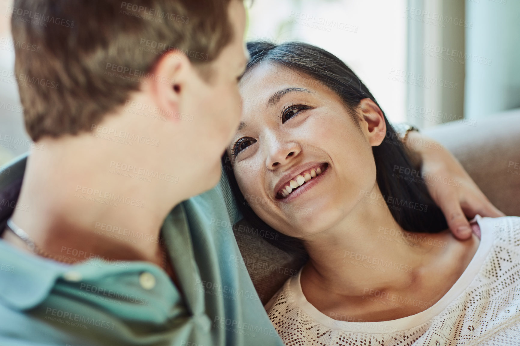 Buy stock photo Cropped shot of a happy young couple relaxing on their couch at home