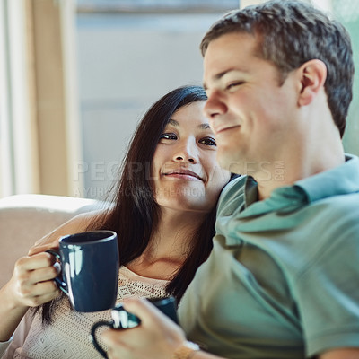 Buy stock photo Cropped shot of a happy young couple relaxing on their couch at home