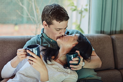 Buy stock photo Cropped shot of a n affectionate couple kissing at home