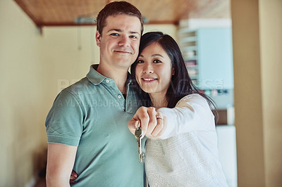 Buy stock photo Shot of a couple holding the keys to their home