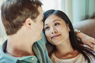 Buy stock photo Cropped shot of a happy young couple relaxing on their couch at